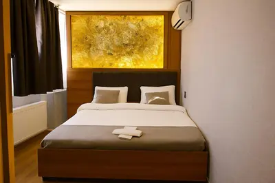 a bedroom with a bed with a white towel on it at CALENBERG HOTEL in Istanbul