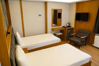 a hospital room with two beds and a chair at CALENBERG HOTEL in Istanbul