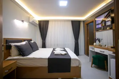 a hotel room with a bed with a desk and a sink at BLAU GRÜN İSTANBUL OTEL in Istanbul
