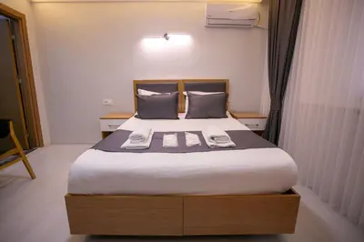 a bedroom with a bed with two towels on it at BLAU GRÜN İSTANBUL OTEL in Istanbul