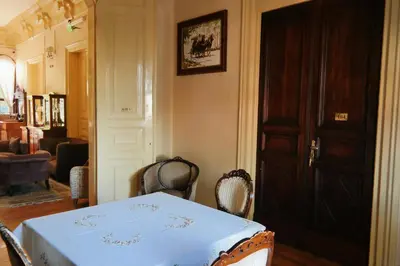 a room with a table and two chairs and a door at Büyükada Anastasia Meziki History Mansion in Buyukada