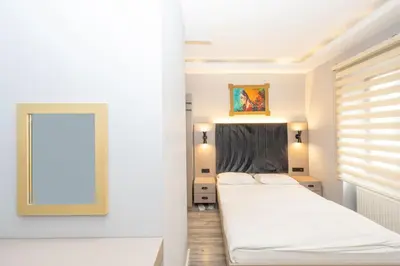 a bedroom with two beds and a mirror at Cirrus Suites in Istanbul