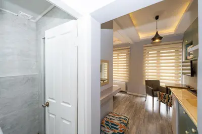 a kitchen and dining room with a white door at Cirrus Suites in Istanbul