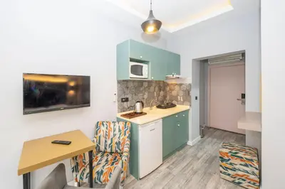 a kitchen with a table and chairs in a room at Cirrus Suites in Istanbul