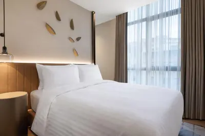 a hotel room with a white bed and a window at Marriott Executive Apartments Istanbul Fulya in Istanbul