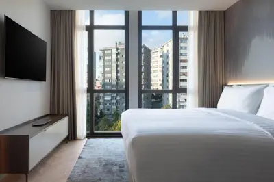 a hotel room with a bed and a large window at Marriott Executive Apartments Istanbul Fulya in Istanbul