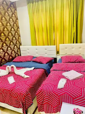 two beds sitting next to each other in a bedroom at White Suites Hotel İstanbul in Istanbul