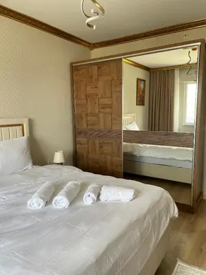 a bedroom with a bed with three towels on it at King Panorama Suite HI9 in Esenyurt