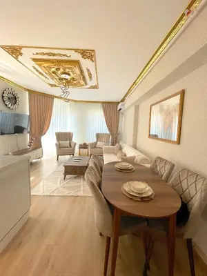 a living room with a table and a couch at King Panorama Suite HI9 in Esenyurt