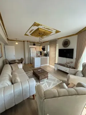 a living room with white couches and a tv at King Panorama Suite HI9 in Esenyurt