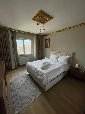 a bedroom with a large white bed and a window at King Panorama Suite HI9 in Esenyurt