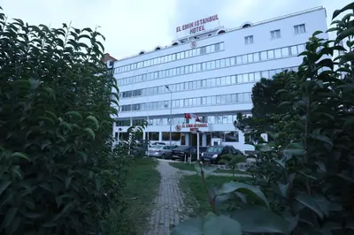 a hotel building with cars parked in front of it at El Emin İstanbul Hotel in Istanbul