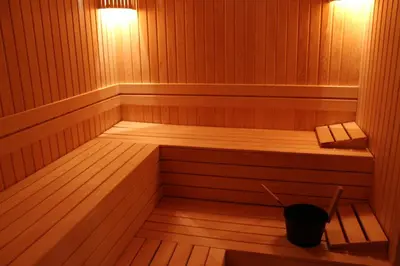 a sauna with a bench and a bucket in it at El Emin İstanbul Hotel in Istanbul