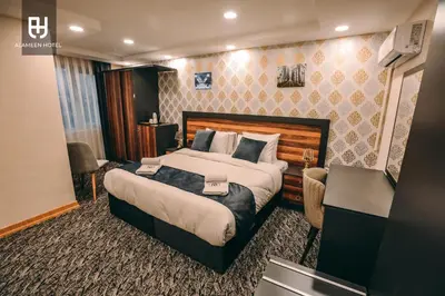 a hotel room with a large bed and a desk at El Emin İstanbul Hotel in Istanbul