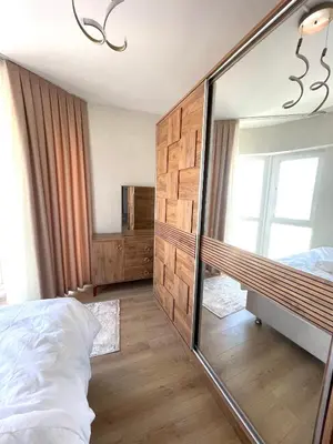 a bedroom with a large mirror and a bed at Two Bedroom King Suite BH46 in Esenyurt