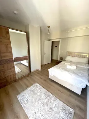 a bedroom with a white bed and a large mirror at Two Bedroom King Suite BH46 in Esenyurt