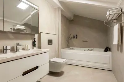 a bathroom with a tub and a toilet and a sink at Trademark Collection By Wyndham Operla İstanbul Airport Hotels & Spa in Arnavutköy