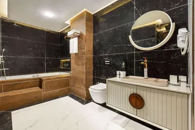 a bathroom with a tub and a toilet and a sink at Trademark Collection By Wyndham Operla İstanbul Airport Hotels & Spa in Arnavutköy