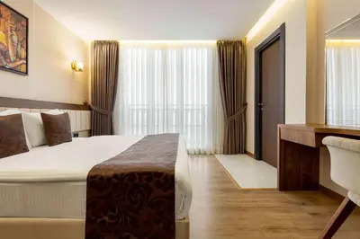a hotel room with a bed and a desk at Trademark Collection By Wyndham Operla İstanbul Airport Hotels & Spa in Arnavutköy