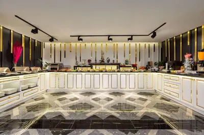 a restaurant with a marble floor and white cabinets at Trademark Collection By Wyndham Operla İstanbul Airport Hotels & Spa in Arnavutköy
