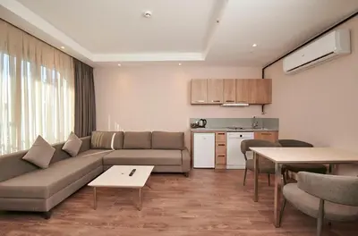 a living room with a couch and a kitchen at Livinton İstanbul Ataşehir in Istanbul