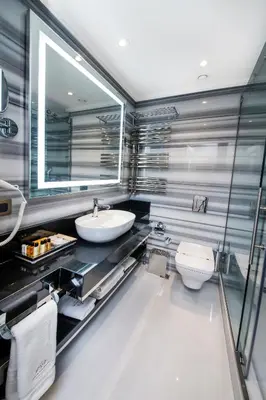 a bathroom with a sink and a toilet and a mirror at MANORS HOTEL in Istanbul