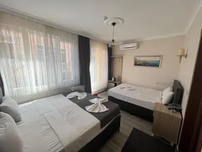 a hotel room with two beds with towels on them at Oren Hotel in Istanbul