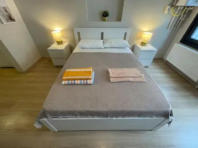 a bedroom with a large bed with two night stands at Apt w/ Balcony in center,5 mn walk to Istiklal in Istanbul