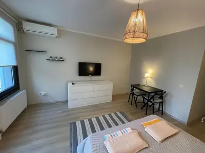 a bedroom with a bed and a television and a table at Apt w/ Balcony in center,5 mn walk to Istiklal in Istanbul