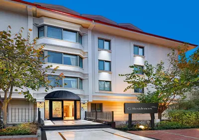 a white building with a sign in front of it at Ulus G Residences in Istanbul