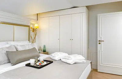 a white bed with towels and a tray of food on it at Ulus G Residences in Istanbul