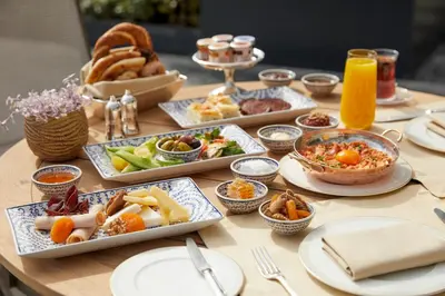a table with many plates of food on it at The Peninsula Istanbul in Istanbul