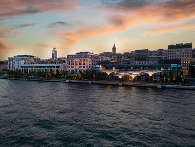 a view of a city from the water at sunset at The Peninsula Istanbul in Istanbul