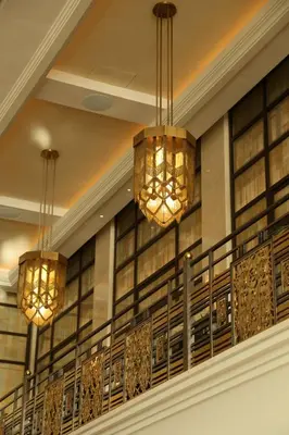 two chandeliers hanging from a balcony in a building at The Peninsula Istanbul in Istanbul