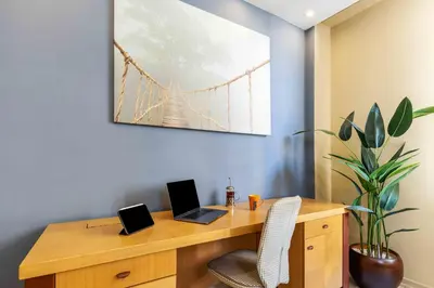 a wooden desk with two laptops on top of it at Cihangir rooms in Istanbul