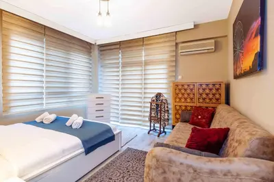 a bedroom with a bed and a couch at Cihangir rooms in Istanbul