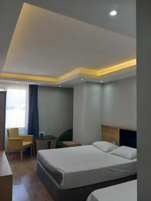 a bedroom with a bed and a table and a chair at Asem Palace in Istanbul