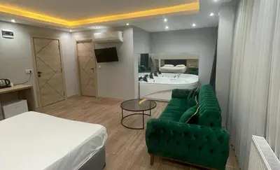 a living room with a green couch and a bed at Asem Palace in Istanbul