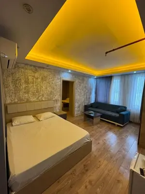a bedroom with a large bed and a couch at Asem Palace in Istanbul