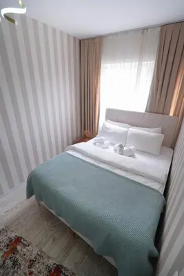 a bedroom with a large bed with a window at Luxe Suite HA8 in Esenyurt