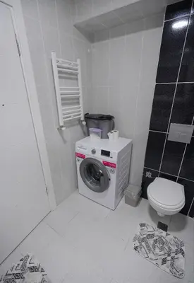 a bathroom with a washing machine and a toilet at Luxe Suite HA8 in Esenyurt