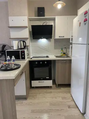a kitchen with white appliances and a white refrigerator at Luxe Suite HA8 in Esenyurt