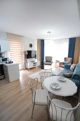 a living room with a couch and a table and chairs at King Suite OK0 in Esenyurt