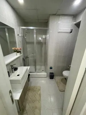 a bathroom with a shower and a sink and a toilet at King Suite OK0 in Esenyurt