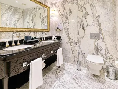 a bathroom with a sink and a toilet and a mirror at Dekalb Hotel in Istanbul