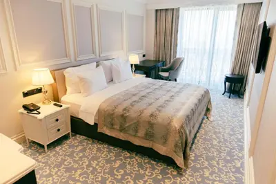 a hotel room with a bed and a desk at Dekalb Hotel in Istanbul
