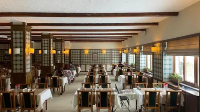 a restaurant with tables and chairs and people sitting at tables at Beceren Hotel in Bursa