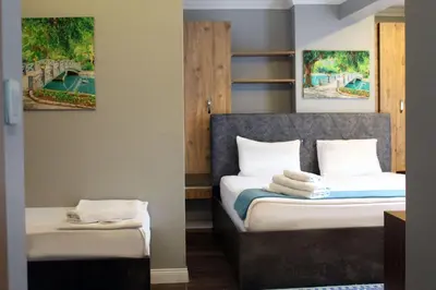 a hotel room with two beds and paintings on the wall at biglife hotel in Istanbul