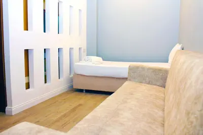 a living room with a couch and a bed at biglife hotel in Istanbul