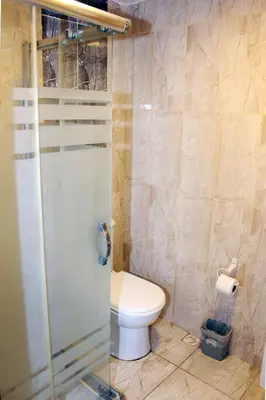 a bathroom with a toilet and a glass shower at biglife hotel in Istanbul